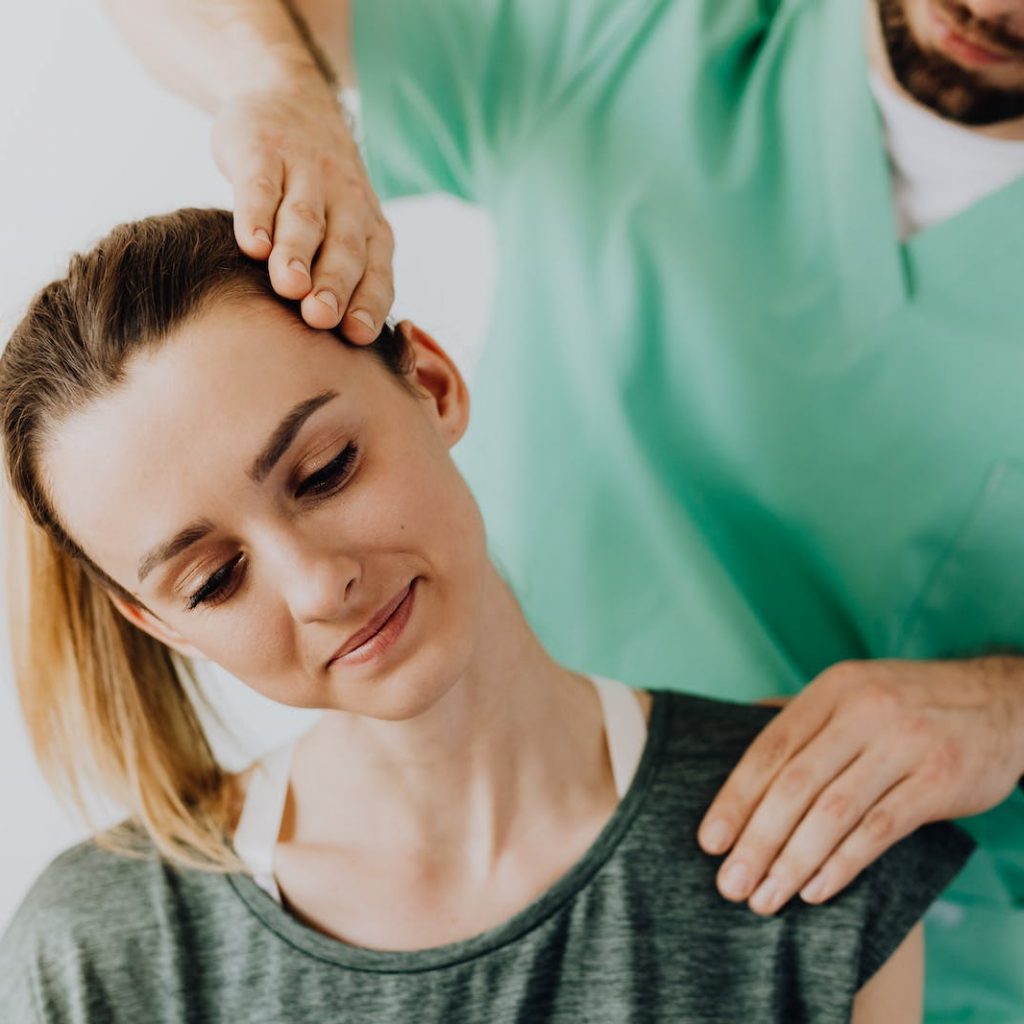 Professional Massage Therapist Treating a Female Patient's Injured Neck