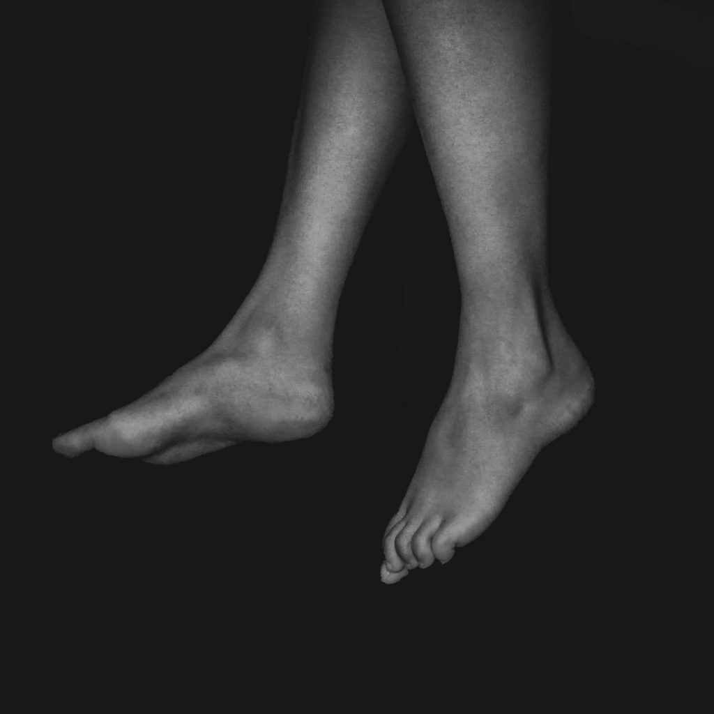 a black and white photo of a person's legs