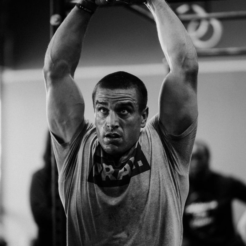 a man in a gym lifting a barbell